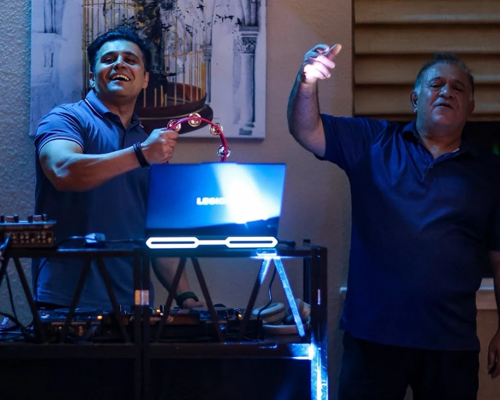 DJ Alphire and a guest dancing by the DJ booth