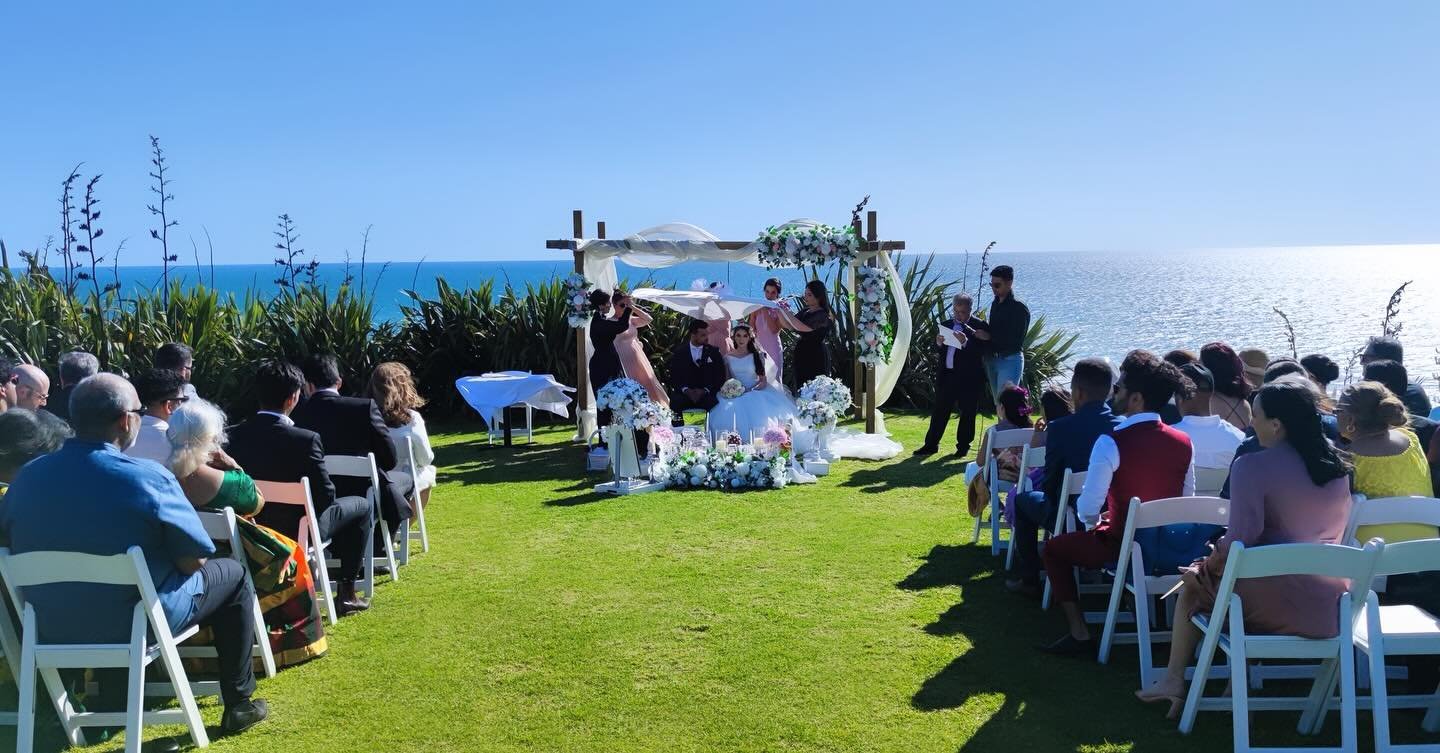 Outdoor wedding ceremony overlooking the ocean.