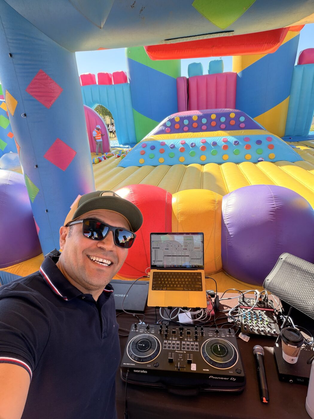 DJ Alphire at the decks at a private event with blue controller lighting